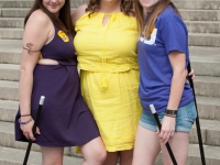 Three female students pose for a photo on the front steps of the LSU Law Center