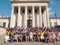 A group of people pose for a photo on the front steps of the LSU Law Center