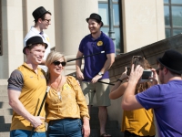 A man and woman pose for a photo on the front steps of the LSU Law Center