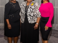A group photo of three women wearing semi-formal attire