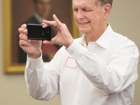 A man takes photos with his cell phone
